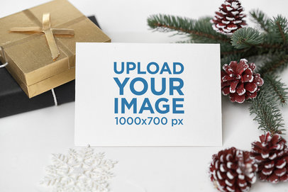 Mockup of a Postcard Surrounded by Christmas Decorations