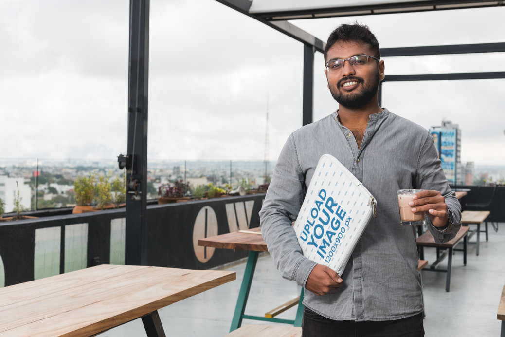 Laptop Sleeve Mockup of a Man Holding a Computer on a Terrace