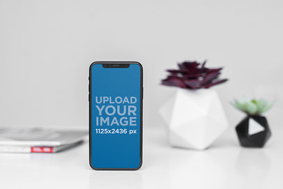  Mockup of an iPhone 11 Pro Standing by Some Plant Pots 2123-el