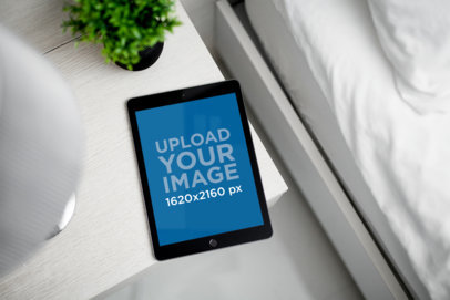 Mockup of an iPad Mini Placed on a Clear Night Table 2211-el
