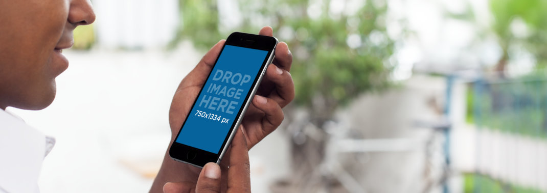 iPhone Mockup of a Young Black Man Using iPhone 6 at a Terrace