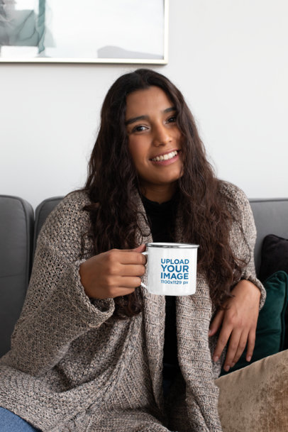 12 oz Enamel Mug Mockup Featuring a Woman Sitting on a Couch 