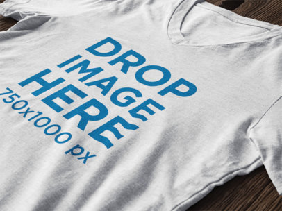 Apparel Mockup of a T-Shirt Over a Wooden Table