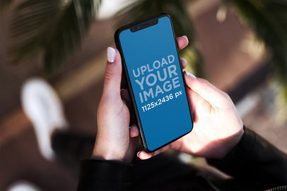 iPhone 11 Pro Mockup Featuring a Woman Holding Her Phone