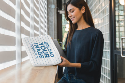 Laptop Sleeve Mockup Featuring a Woman at an Office