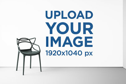 Mockup of an Art Print on a Big Wall Behind a Lonely Chair 2205-el1