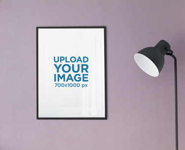 Mockup of a Poster Frame Hanging Next to a Floor Lamp 2021-el1