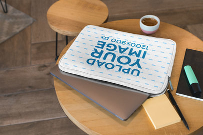 Mockup of a Sublimated Laptop Sleeve over a Wooden Table
