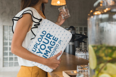 Laptop Sleeve Mockup Featuring a Woman at a Cafe