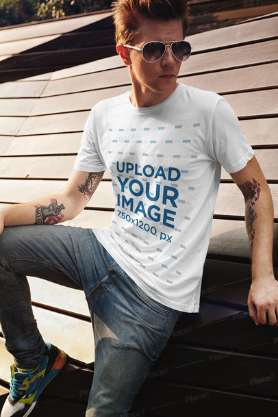T-Shirt Mockup of a Tattooed Man with Sunglasses Posing