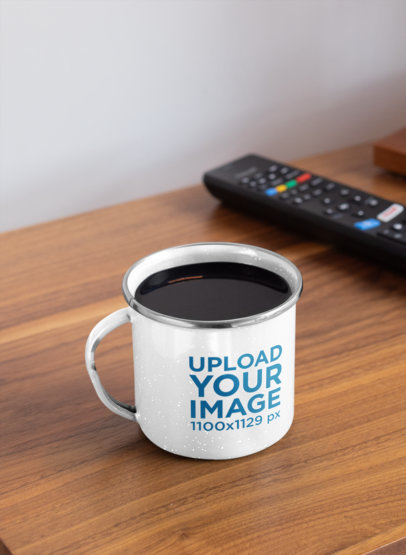 Mockup of an Enamel Silver Rim Mug Placed Next to a TV Remote