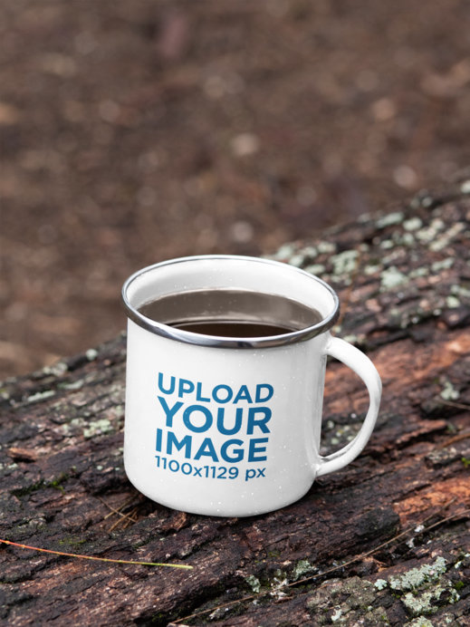 Mockup of a 12 oz Enamel Mug with a Silver Rim Placed on a Fallen Tree 