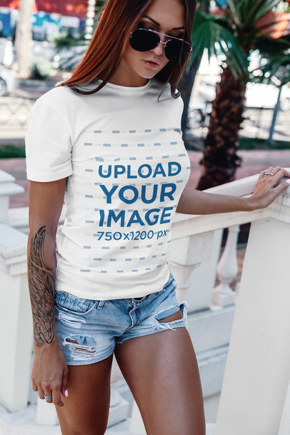 T-Shirt Mockup Featuring a Tattooed Woman with Sunglasses
