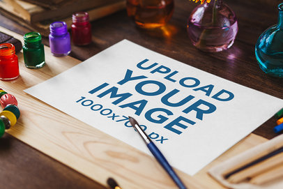 Angled Sketch Paper Mockup with a Brush and Watercolor Paints 