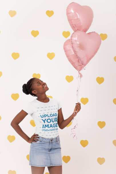 T-Shirt Mockup Featuring a Woman Holding Heart-Shaped Foil Balloons
