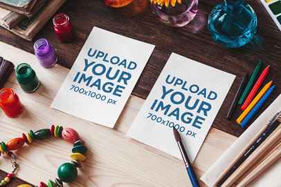 Watercolor Mockup Featuring Two Sketch Paper Lying on a Wooden Table 