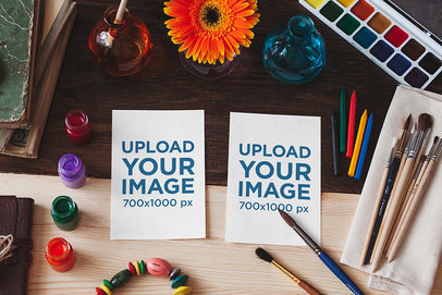 Mockup Featuring Two Sketch Papers Surrounded by Watercolor Paints and Brushes 2277-el1