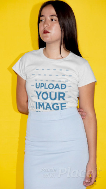 T-Shirt Video Featuring a Serious Woman Posing in Front of a Bright Wall