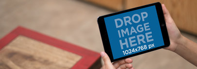 Tablet Mockup of a Young Man Holding a Black iPad Mini