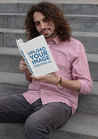Mockup of a Man Reading a Book Sitting on a Staircase
