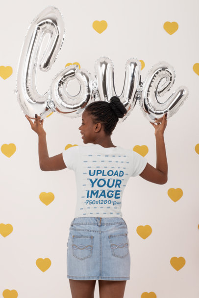 Back-View T-Shirt Mockup of a Woman Holding Valentine's Day Balloons