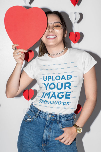 T-Shirt Mockup of a Smiling Woman Holding a Paper Heart