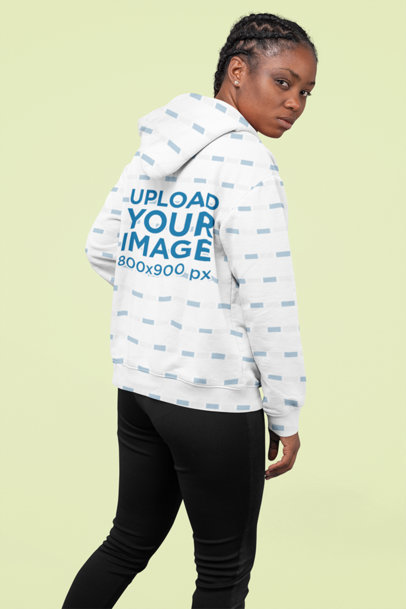 Sublimated Hoodie Mockup Featuring a Woman with Braids Posing at a Studio