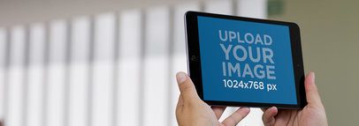 Tablet Mockup of a Black iPad Held With Both Hands