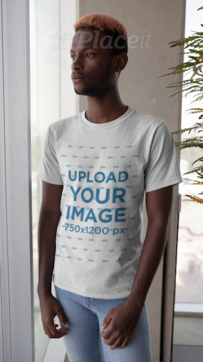T-Shirt Video Featuring a Young Man With Dyed Hair Standing by a Window 