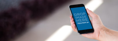 Mockup Template of a Black iPhone 6s With Blurry Background