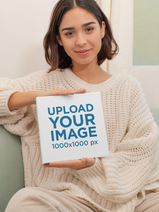 Mockup of a Short-Haired Woman Holding a Square Book With Both Hands