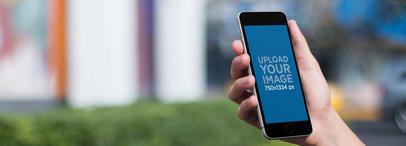 Black iPhone 6 Mockup Template Being Held Outdoors