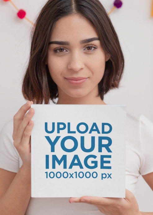 Mockup of a Woman Proudly Holding a Square-Shaped Book