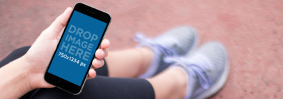 iPhone 6s Mockup of a Young Woman at a Running Track