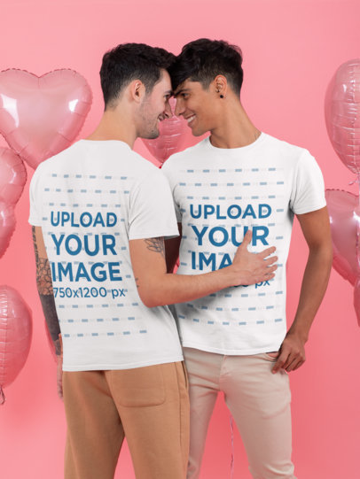 T-Shirt Mockup of a Romantic Couple Looking at Each Other at a Studio with Heart-Shaped Balloons