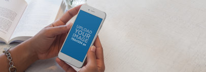 iPhone Mockup of a Female Reading a Book While Using iPhone