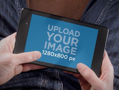 Mockup of a Man Playing on His Nexus 7 