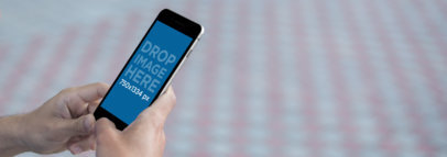 Black iPhone 6s Mockup Template in an Urban Setting