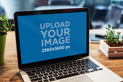 Mockup of a MacBook Pro on a Rustic Desk