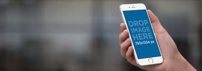 iPhone 6s Mockup Template Held Over a Blurry Background