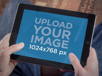 Mockup of a Man Holding an iPad in Landscape Position