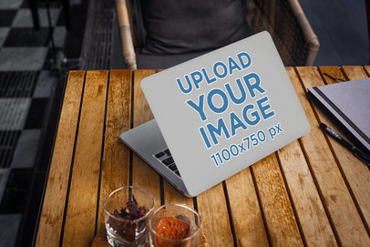 Laptop Cover Mockup Featuring a Computer on a Wooden Table