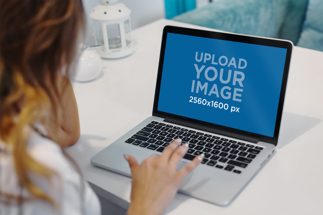 Mockup of a Woman Working on a MacBook