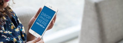 Mockup of a Woman Using a Silver iPhone 7 Plus at Home