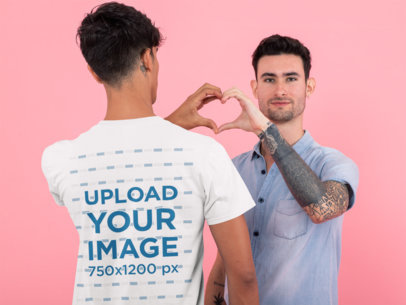 Back View Mockup of a Man with a T-Shirt Doing a Heart Sign with His Boyfriend 31206
