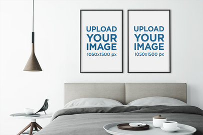 Mockup of Two Art Prints Hanging in a Modern and Minimalistic Bedroom 