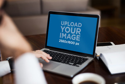 MacBook Pro Mockup Over a Crowded Desk
