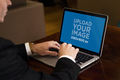 Mockup of a Businessman Using a MacBook