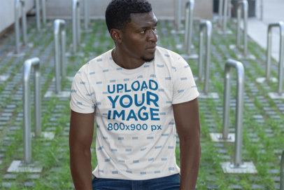 Sublimated T-Shirt Mockup Featuring a Man with Bike Racks in the Background