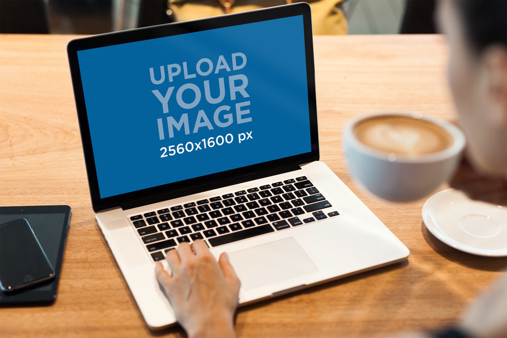 MacBook Pro Mockup Featuring a Person Drinking Coffee